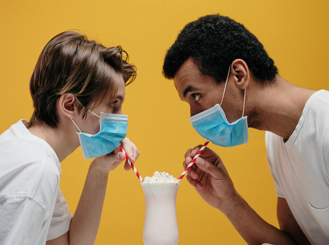 couple with mask having a smoothie